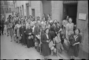 Civilians lined up for water in one of the streets in southern Florence, Italy, World War II - Photograph taken by George Kaye