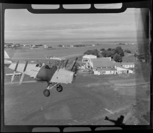 De Havilland DH 83 Tiger Moth biplane, in flight over Auckland Aero Club, Auckland Aero Club, Mangere, Manukau City, Auckland Region