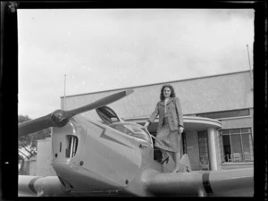 Miss Stormont, standing on the wing of an aircraft, at Auckland Aero Club, Mangere, Auckland