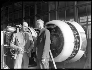 Willard Whitney Straight, of British Overseas Airways Corporation, with Mr Bolt, standing in front of aircraft engines, Auckland