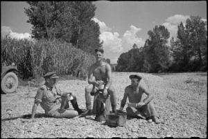 New Zealand soldiers brew up in the dry Pisa River bed near Florence, Italy, World War II - Photograph taken by George Kaye