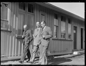 Mr Bolt, Lord Knollys, and Sir Leonard Isitt, walking in an unidentified location, during British Overseas Airways Corporation's visit to New Zealand