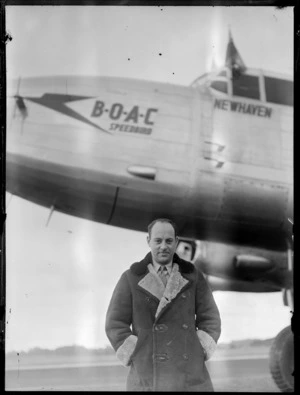 Mr Whitney-Straight in front of a BOAC (British Overseas Airways Corporation) Lancastrian aircraft, during visit to New Zealand, location unidentified