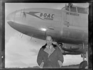 Sir Whitney-Straight in front of a BOAC (British Overseas Airways Corporation) Lancastrian aircraft 'New Haven', during visit to New Zealand, location unidentified