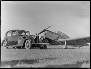 Mr Common's Daimler motorcar beside an airplane