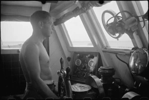 Coxwain at the wheel of a World War II naval motor launch on patrol in the Adriatic - Photograph taken by George Bull
