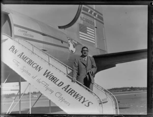Portrait of Mr Heineman descending stairs from a PAWA Clipper Celestial NC 88959 passenger plane, Whenuapai Airfield, Auckland