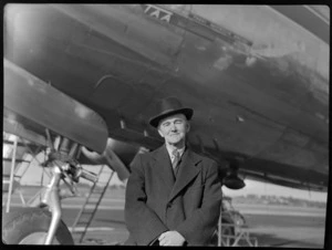 Mr Garadus, formerly Director of Education, next to TAA (Trans Australia Airlines) aircraft, at Whenuapai Air Base