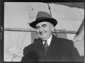 Bristol Freighter Tour, portrait of J Sawers (General Manager for NZR) in front of Bristol Freighter transport plane 'Merchant Venturer' G-AIMC while being loaded, Paraparaumu Airport, North Wellington Region