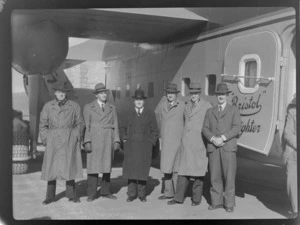 Bristol Freighter Tour, group portrait of NZ NAC personnel (L to R) R Gardiner, J Foley, F Maurice Clarke (General Manager), J Jennings, T O'Connell in front of Bristol Freighter transport plane 'Merchant Venturer' G-AIMC, Paraparaumu Airport, North Wellington Region