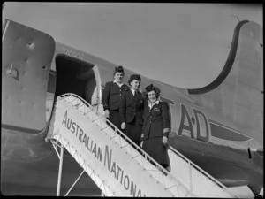 Flight attendants - Miss L Armstrong (closet to aircraft door) of TAA (Trans Australia Airlines), Miss P Woolley of TEA (Tasman Empire Airways) and Miss M Harrison of TAA