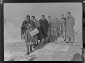 Unidentified members of Bristol Freighter crew, with guide Rangi, walking along hot thermal springs and bubbling mud pools, Rotorua, Bay of Plenty