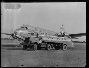 Fuel truck of Vacuum Oil Company, refuelling aircraft Douglas DC-4 Clipper Racer, PAWA (Pan America World Airways), unidentified location