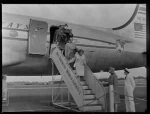 Unidentified people disembarking aircraft Douglas DC-4 Clipper Racer, PAWA (Pan America World Airways), unidentified location
