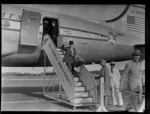 Mr Clapshaw, manager of Rendells [department store?], disembarking from aircraft Douglas DC-4 Clipper Racer, PAWA (Pan America World Airways), unidentified location