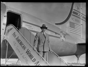 Mr Fricketts, [of 'Boots' pharmacy?], next to aircraft Douglas DC-4 Clipper, Racer PAWA (Pan America World Airways), unidentified location