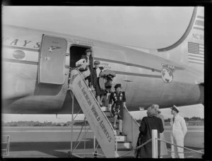 Unidentified women disembarking from aircraft Douglas DC-4 Clipper Racer, PAWA (Pan America World Airways), unidentified location