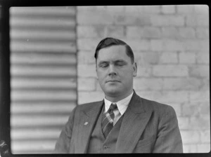 Portrait of Marlborough Aero Club Secretary R J Taylor in front of an unknown building
