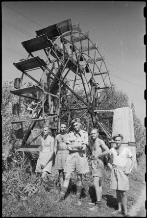 Large water wheel interests World War II New Zealand soldiers in Jesi, Italy - Photograph taken by George Kaye