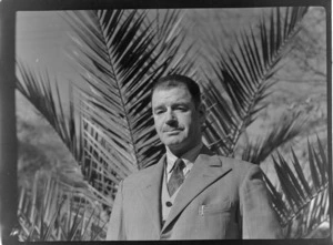 Portrait of Marlborough Aero Club President Dr N F Boag in front of a palm tree, location unknown