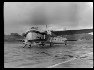 Bristol Freighter Tour, view of Piper J-3C50 Cub ZK-AHD passenger plane in front of Bristol Freighter transport plane 'Merchant Venturer' G-AIMC, Rongotai Airport, Wellington City