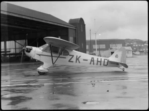 Bristol Freighter Tour, view of J Franklin's Piper J-3C50 Cub ZK-AHD aeroplane in front of a hangar, Rongotai Airport, Wellington City