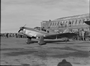 Percival Proctor aircraft, with hangar and crowd in background, during the Bristol Freighter transport aeroplane tour, at Otago Aero Club