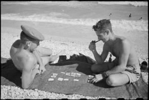 G R Ireland and T W Spooner play cards on the beach near Ancona, Italy, in World War II - Photograph taken by George Kaye