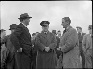 Mr NE Higgs, Air Vice-Marshal A de T Nevill, Captain R Ellison, and other unidentified men at Paraparaumu Airport, Kapiti Coast District, during Bristol Freighter transport aeroplane tour