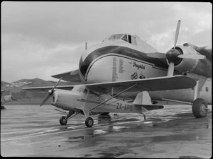 Bristol Freighter Tour, view of an Auster J/1 Autocrat ZK-APO plane in front of Bristol Freighter transport plane 'Merchant Venturer' G-AIMC, Rongotai Airport, Wellington City