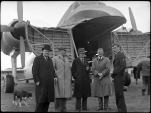 Mr TA Barrow (Air Secretary), left, with Mr McDonald (MD), Mr Smith (MD), Captain R Ellison, and Mr MF Elliot, in front of Bristol Freighter transport aeroplane 'Merchant Venturer', Paraparaumu Airport, Kapiti Coast District