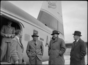 Captain R Ellison, Sir Leonard Isitt, EA Gibson, and F Maurice Clarke, and an unidentified man, alongside Bristol Freighter transport aeroplane G-AIMC, Rongotai Airport, Wellington