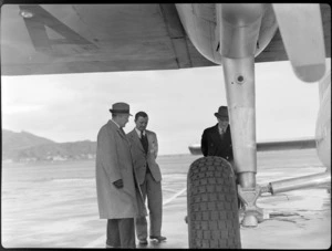 The Governor-General Sir Bernard Freyberg, left, with Captain Ellison and General Puttick, standing under the wing of Bristol Freighter transport aeroplane 'Merchant Venturer', Rongotai Airport, Wellington