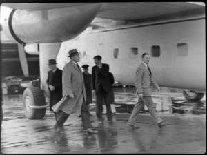 Sir Bernard Freyberg, Captain Ellison, and other unidentified men, walking on the tarmac at Rongotai Airport, Wellington, during their inpspection of Bristol Freighter transport aeroplane 'Merchant Venturer'