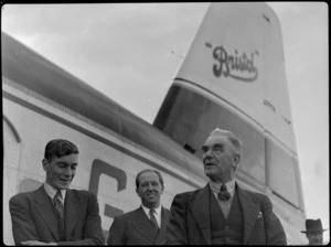 Mr Elliot, Mr Higgs, and Mayor of Masterton Mr W Kemp, alongside Bristol Freighter transport aeroplane 'Merchant Venturer', [at Hood Aerodrome?], Masterton