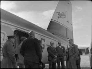 Group of men alongside Bristol Freighter transport aeroplane 'Merchant Venturer', including on right; Mayor of Masterton Mr W Kemp, Mr Higgs, and Mr E Heyder (President of Wairarapa and Ruahine Aero Club), at [Hood Aerodrome?], Masterton
