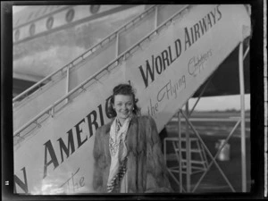 Miss T Barker, standing by Pan American World Airways aircraft