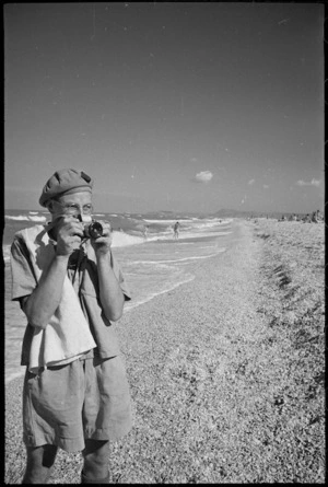 G R Waters, with camera, records day on beach near Ancona, Italy, World War II - Photograph taken by George Kaye