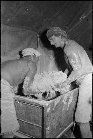 Dough being mixed by two staff at 2 New Zealand Field Bakery in Italy in World War II - Photograph taken by George Kaye