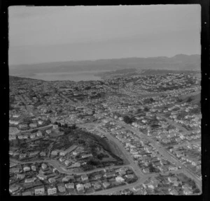 View over the Wellington City western suburb of Karori with Karori Road in foreground, looking to Wellington Harbour