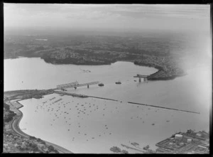 Auckland Harbour Bridge under construction, including Westhaven Marina and Northcote in the distance