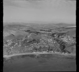 View over the coastal settlement of Pukerua Bay and Ocean Parade Road with beach batches and State Highway 1 south to Plimmerton, Porirua District, Wellington Region