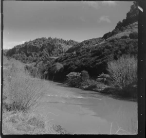 View of a river with bush covered hills beyond, Mahoenui district, Waikato Region