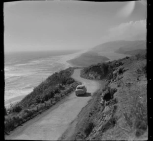 View of the Mokau Coastline with Mokau Coastal Road (State Highway 3 north) and car in foreground down to the Mokau River and settlement, Waikato Region