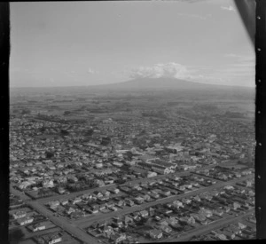 The town of Hawera with South Road in foreground looking to the A & P Showground at the edge of town with farmland and Mount Taranaki beyond