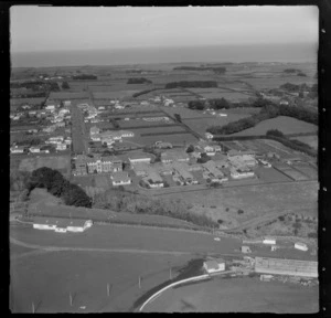 The town of Hawera and Hawera Hospital with tennis court, with the A & P Showground cricket pitch in foreground, South Taranaki Region