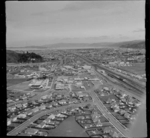 The suburb of Naenae with Naenae Olympic Pool, Cambridge Terrace, Naenae Railway Station and College, looking south to Lower Hutt City, Wellington Region