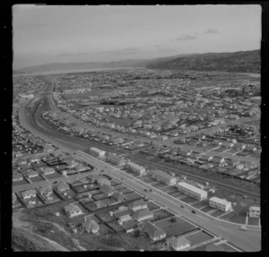 The suburb of Naenae and Cambridge Terrace in foreground with Naenae College and Railway Station beyond, looking south to Lower Hutt City, Wellington Region