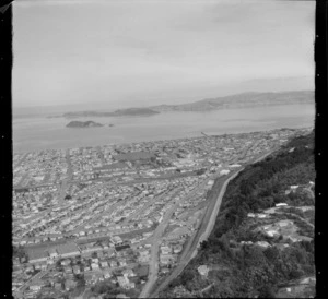 View south over the Lower Hutt Valley suburb of Petone with the Western Hutt Road in foreground to the Petone Recreational Ground and Petone Beach, to Wellington City and Harbour beyond