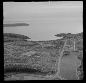 View of the Porirua suburb of Titahi Bay and Main Road with Onepoto and Kura Parks to Mana Island beyond, Porirua District, Wellington Region